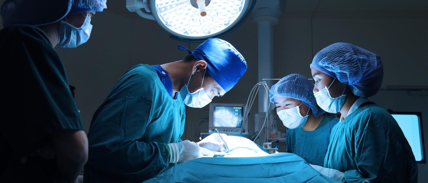 General Surgery with surgeons in scrubs working on a patient