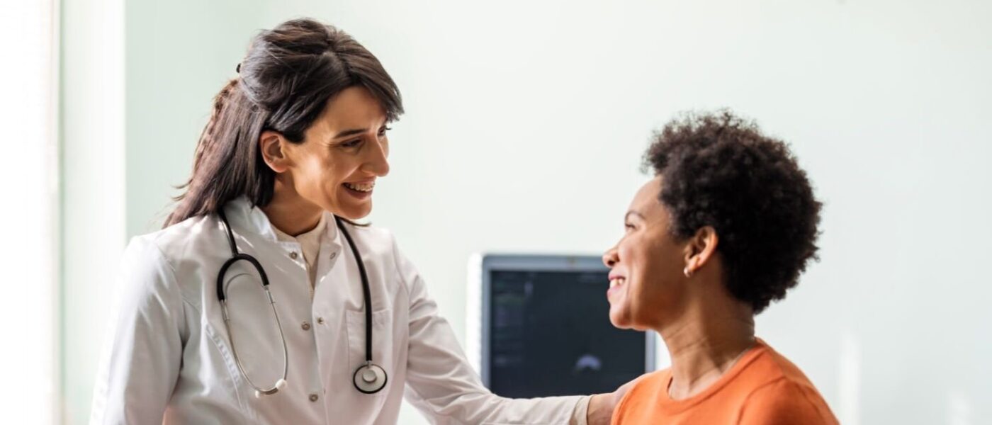 Female medical practitioner reassuring a patient